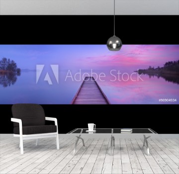 Bild på Jetty on a still lake at dawn in The Netherlands